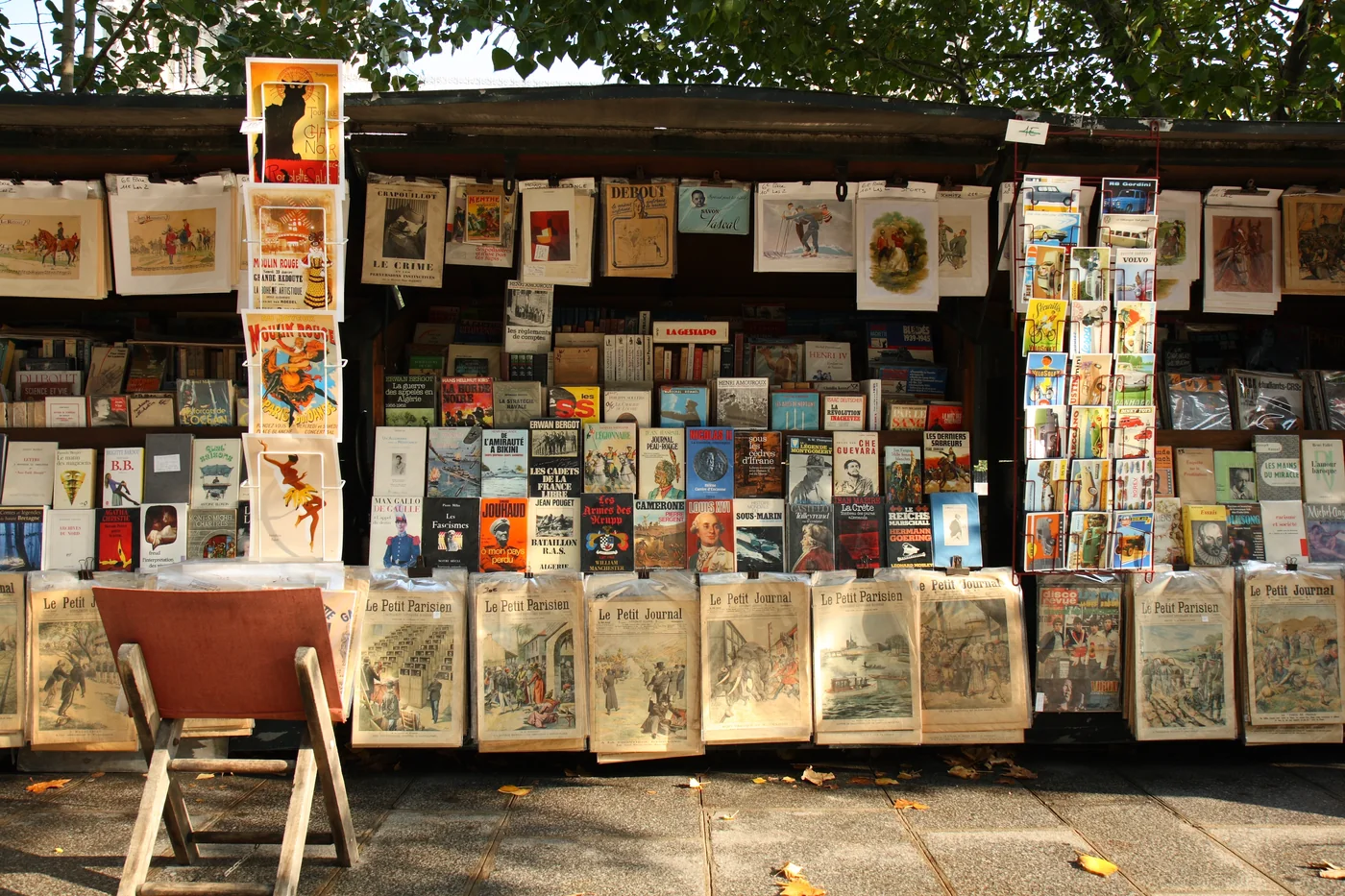 A stand of a bouquiniste (French term for second-hand books resellers), in Paris, near the Cathedral Notre-Dame of Paris. Bouquinistes can be considered a landmark of Paris.?