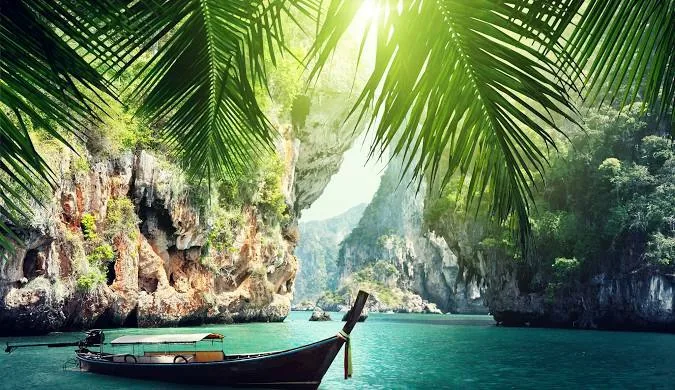 Long-tail boat on a tropical limestone lagoon in Thailand